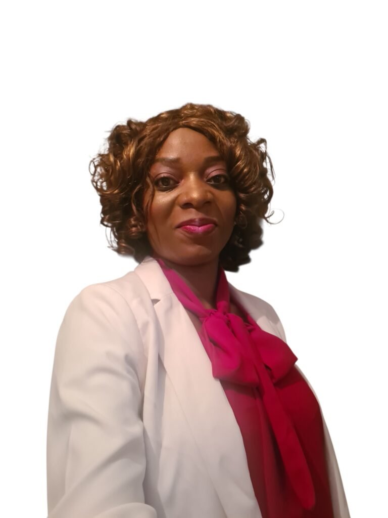 Portrait of a woman with curly brown hair, wearing a white blazer and bright pink scarf, smiling against a white background.